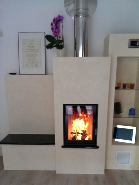 Weißer Heizkamin mit Feuer im eingerichteten Wohnzimmer